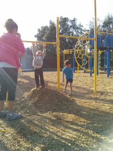 We visited the Elementary School playground today. It's been a while since we did. J and I made you a woodchip moutain so you could reach the bar